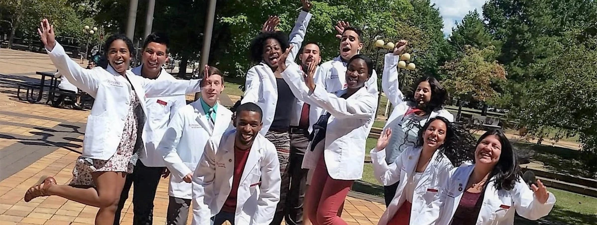 ODASIS students pictured outside smiling and jumping